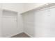 Functional walk-in closet with multiple levels of rods and shelving for clothes storage at 17225 W Calle Lejos --, Surprise, AZ 85387