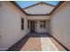 Inviting front entryway with stone pavers and a neutral color scheme, creating a warm and welcoming atmosphere at 17225 W Calle Lejos --, Surprise, AZ 85387