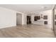 Open-concept living area seamlessly connects to the kitchen with light wood flooring and abundant natural light at 17225 W Calle Lejos --, Surprise, AZ 85387