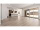Bright and airy living area with light wood floors, leading into a modern kitchen with stainless steel appliances at 17225 W Calle Lejos --, Surprise, AZ 85387