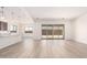 Bright open living space with light wood flooring and modern recessed lighting extending to sliding glass doors at 17225 W Calle Lejos --, Surprise, AZ 85387