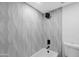 Shower and bathtub with modern wall tile at 8562 E Indian School Rd # E, Scottsdale, AZ 85251