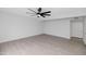 Spacious bedroom with ceiling fan and wood-look tile flooring at 8562 E Indian School Rd # E, Scottsdale, AZ 85251