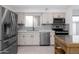 Modern kitchen with stainless steel appliances and white shaker cabinets at 8562 E Indian School Rd # E, Scottsdale, AZ 85251