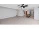 Bright living room with modern ceiling fan and stylish wood-look tile floors at 8562 E Indian School Rd # E, Scottsdale, AZ 85251