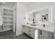 Bathroom with double vanity, marble countertop, and ample storage at 1501 N Miller Rd # 1011, Scottsdale, AZ 85257