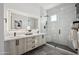 Modern bathroom with a double vanity and a glass shower at 1501 N Miller Rd # 1011, Scottsdale, AZ 85257