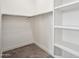 White closet with shelves and hanging rod for storage at 1501 N Miller Rd # 1011, Scottsdale, AZ 85257