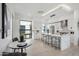 Modern kitchen with white cabinets, marble countertops, and breakfast bar at 1501 N Miller Rd # 1011, Scottsdale, AZ 85257