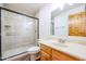 Bathroom with tiled shower, vanity, and mirror at 19927 W Meadowbrook Ave, Litchfield Park, AZ 85340