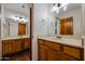 Bathroom with double vanity, wood cabinets, and tile floor at 19927 W Meadowbrook Ave, Litchfield Park, AZ 85340