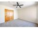 Bright bedroom with wood doors and ceiling fan at 19927 W Meadowbrook Ave, Litchfield Park, AZ 85340