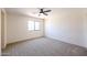 Bright bedroom with ceiling fan and carpet at 19927 W Meadowbrook Ave, Litchfield Park, AZ 85340