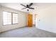 Spacious bedroom with wood door and large window at 19927 W Meadowbrook Ave, Litchfield Park, AZ 85340