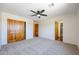 Spacious bedroom with double doors and ceiling fan at 19927 W Meadowbrook Ave, Litchfield Park, AZ 85340