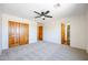 Well-lit bedroom featuring ceiling fan and closet at 19927 W Meadowbrook Ave, Litchfield Park, AZ 85340