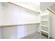 Large walk-in closet with shelves and rods at 19927 W Meadowbrook Ave, Litchfield Park, AZ 85340