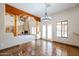 Spacious dining room with tile floors and views into the living room and backyard at 19927 W Meadowbrook Ave, Litchfield Park, AZ 85340