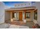 Front entry with wooden door and glass accents at 19927 W Meadowbrook Ave, Litchfield Park, AZ 85340