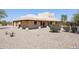 Back view of stucco home with covered patio and desert landscaping at 19927 W Meadowbrook Ave, Litchfield Park, AZ 85340