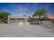 Two-car garage and front view of stucco home at 19927 W Meadowbrook Ave, Litchfield Park, AZ 85340