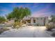 Front view of stucco home with arched entryway at 19927 W Meadowbrook Ave, Litchfield Park, AZ 85340