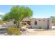 White stucco home with arched entryway and desert landscaping at 19927 W Meadowbrook Ave, Litchfield Park, AZ 85340