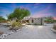 Front view of stucco home with arched entryway at 19927 W Meadowbrook Ave, Litchfield Park, AZ 85340