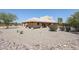 Back view of stucco home with covered patio and desert landscaping at 19927 W Meadowbrook Ave, Litchfield Park, AZ 85340