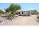 Front view of stucco home with arched entryway and desert landscaping at 19927 W Meadowbrook Ave, Litchfield Park, AZ 85340