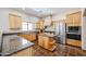 Kitchen features granite countertops, wood cabinets, and stainless steel appliances at 19927 W Meadowbrook Ave, Litchfield Park, AZ 85340