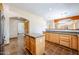 View of kitchen with granite island and stainless steel appliances at 19927 W Meadowbrook Ave, Litchfield Park, AZ 85340