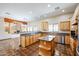 Open concept kitchen with granite island and stainless steel appliances at 19927 W Meadowbrook Ave, Litchfield Park, AZ 85340