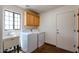 Laundry room with washer, dryer, sink, and cabinets at 19927 W Meadowbrook Ave, Litchfield Park, AZ 85340