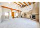 Large living room featuring a fireplace and wood beams at 19927 W Meadowbrook Ave, Litchfield Park, AZ 85340