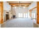 Large living room featuring a fireplace and wood beams at 19927 W Meadowbrook Ave, Litchfield Park, AZ 85340