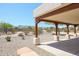 Covered patio with wood beams and desert landscape views at 19927 W Meadowbrook Ave, Litchfield Park, AZ 85340