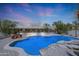 Blue pool with rock features and desert landscape at 19927 W Meadowbrook Ave, Litchfield Park, AZ 85340