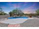 Inviting pool with waterfall feature and desert landscaping at 19927 W Meadowbrook Ave, Litchfield Park, AZ 85340