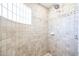 Clean shower with tiled walls and a glass block window at 19927 W Meadowbrook Ave, Litchfield Park, AZ 85340