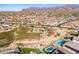 Aerial view of community park, pool, and homes at 12179 E Sereno Rd, Gold Canyon, AZ 85118