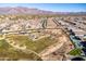 Aerial view of community park, pool, and homes with mountain view at 12179 E Sereno Rd, Gold Canyon, AZ 85118