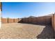 Spacious backyard with gravel covering and block wall fencing at 12179 E Sereno Rd, Gold Canyon, AZ 85118