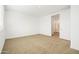 Well-lit bedroom with carpet flooring and adjacent bathroom at 12179 E Sereno Rd, Gold Canyon, AZ 85118