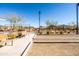 Community bocce ball court with benches and tennis court in background at 12179 E Sereno Rd, Gold Canyon, AZ 85118