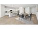 Modern kitchen with white cabinets, island, and dining area at 12179 E Sereno Rd, Gold Canyon, AZ 85118