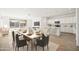 Modern kitchen with white cabinetry, island, and dining area at 12179 E Sereno Rd, Gold Canyon, AZ 85118