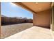 Covered patio with view of gravel backyard and block wall at 12179 E Sereno Rd, Gold Canyon, AZ 85118