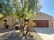 Single-story home featuring a desert-style front yard and an attached two-car garage at 16205 W Berkeley Rd, Goodyear, AZ 85395