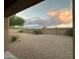 Spacious gravel backyard with palm trees and privacy wall at 45737 W Ranch Rd, Maricopa, AZ 85139
